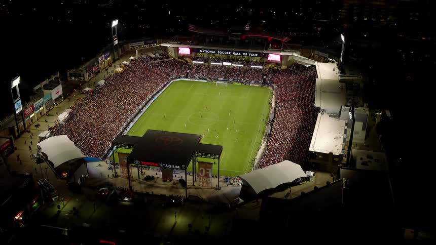 The soccer stadium has a huge crowd watching the game