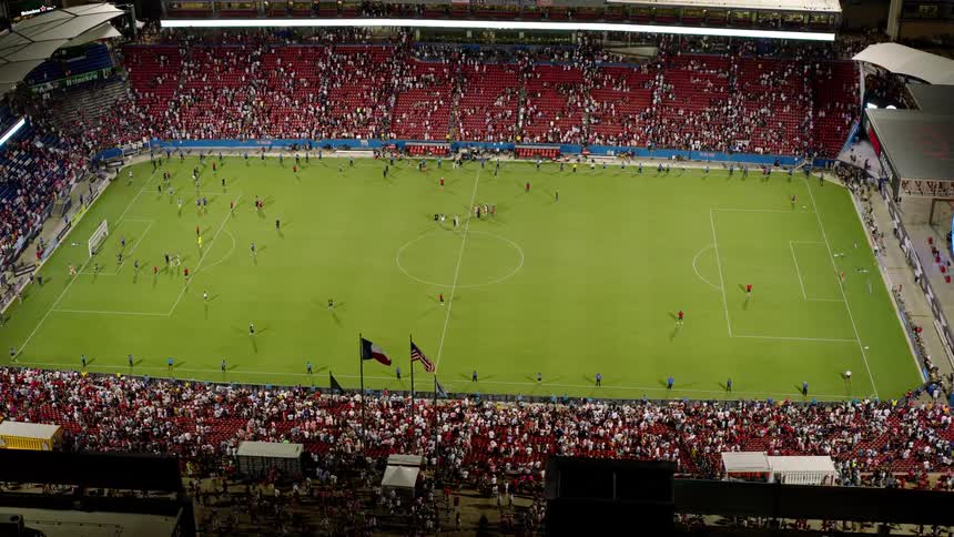 The players are moving around the soccer field