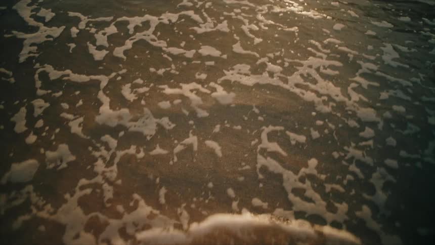 A waves washes up on the beach