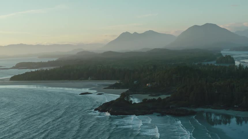 Aerial panorama of an archipelago surrounded by the sea with mountains in the background