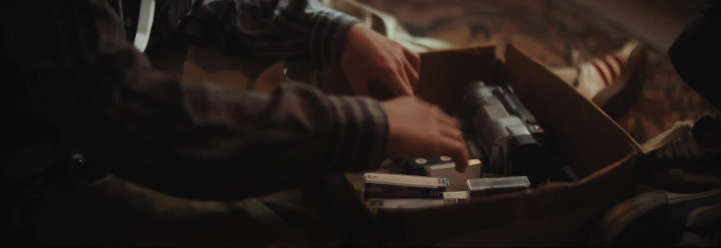 A close up clip of a teenager arranging a box