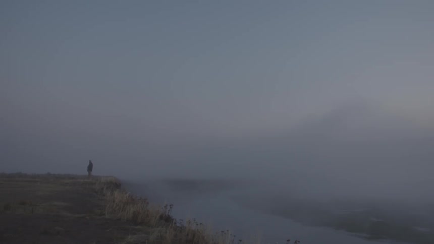 The shore is covered with heavy fog