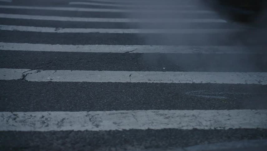 Vehicles pass over the crosswalk