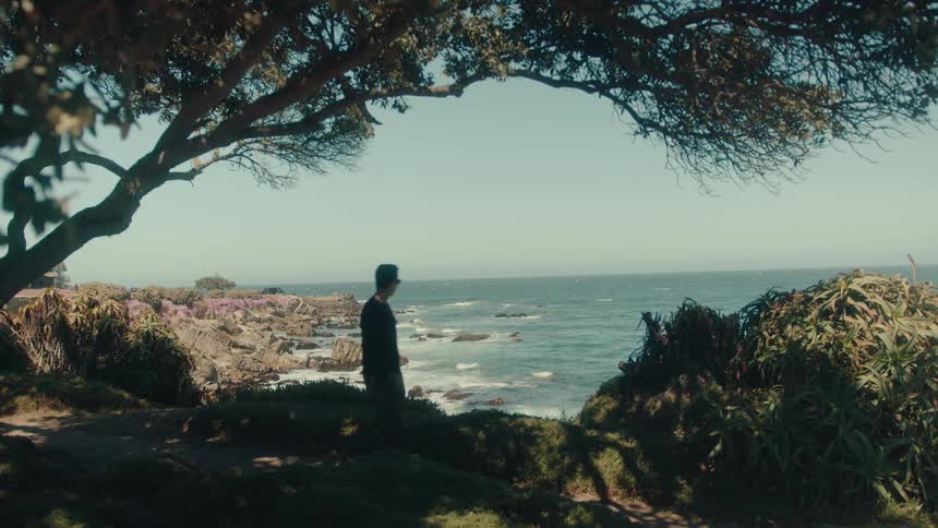 A man walks past the shore