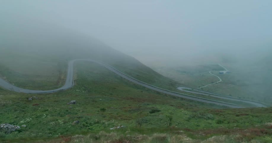 Fog rolls over the green hills