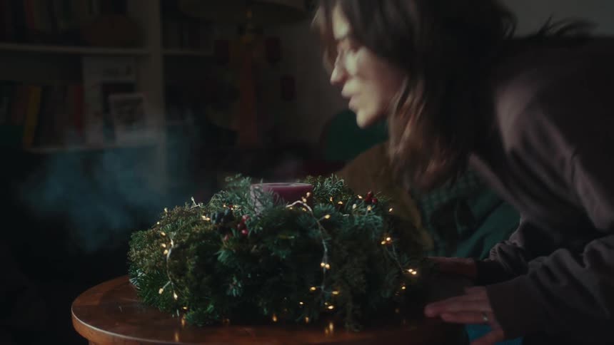 A clip of a lady blowing out a candle
