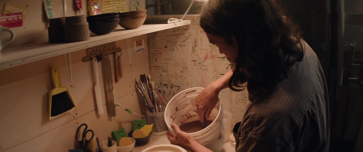 Craftsman preparing materials inside a bucket