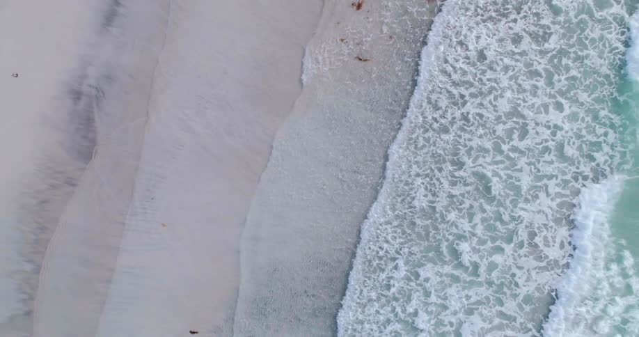 Waves crash on a sandy beach
