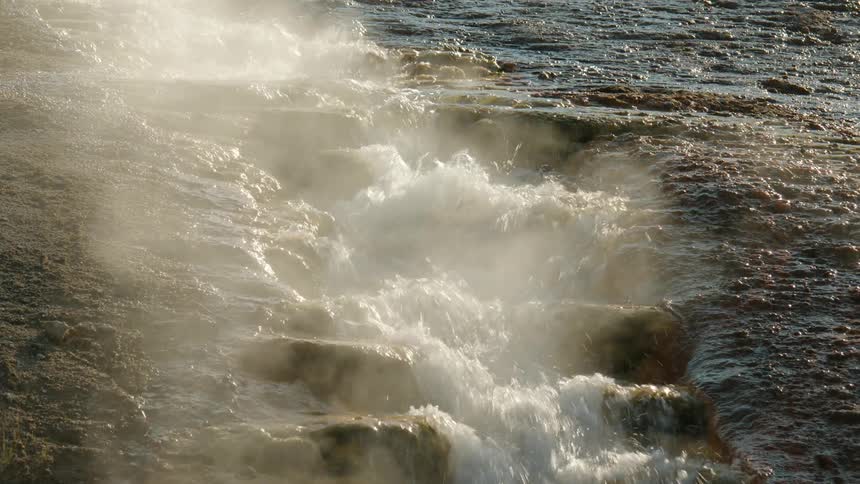 Steam rises from the small stream