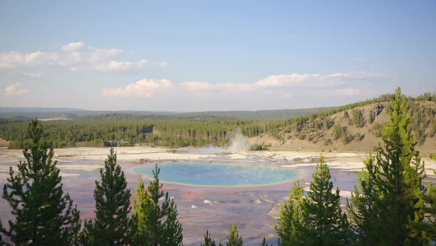 The grand prismatic spring in yellowstone national park with steam rising from the center