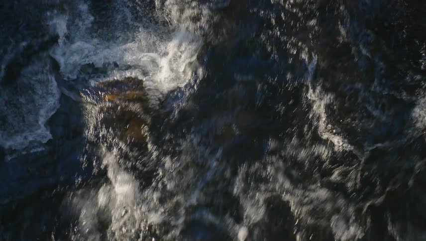 The stream is moving fast on a sunny day