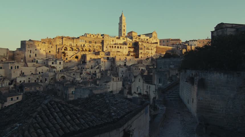 The sunlit cityscape of matera italy with its distinctive cave dwellings and ancient architecture stretching across a hillside