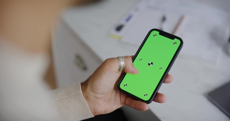 A womans hand is shown using her thumb to flick up on a smartphone screen