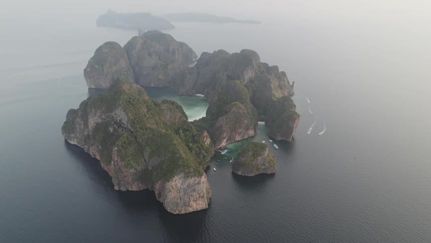 An aerial view of a group of islands with dramatic cliffs lush vegetation and hidden coves