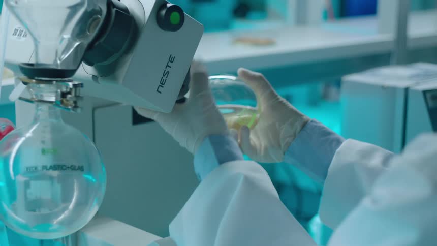 A clip of a lady operating a machine at a scientific lab