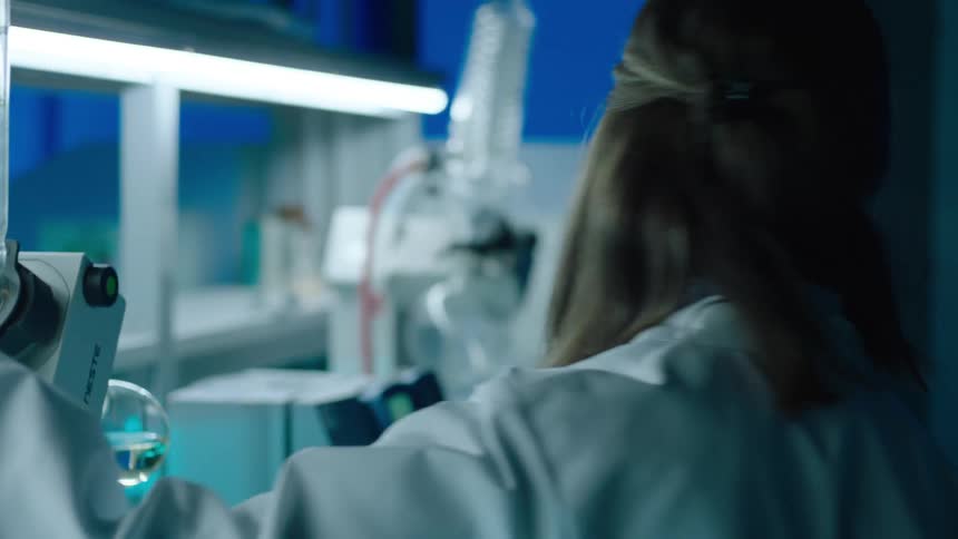 A scientist is experimenting in the lab
