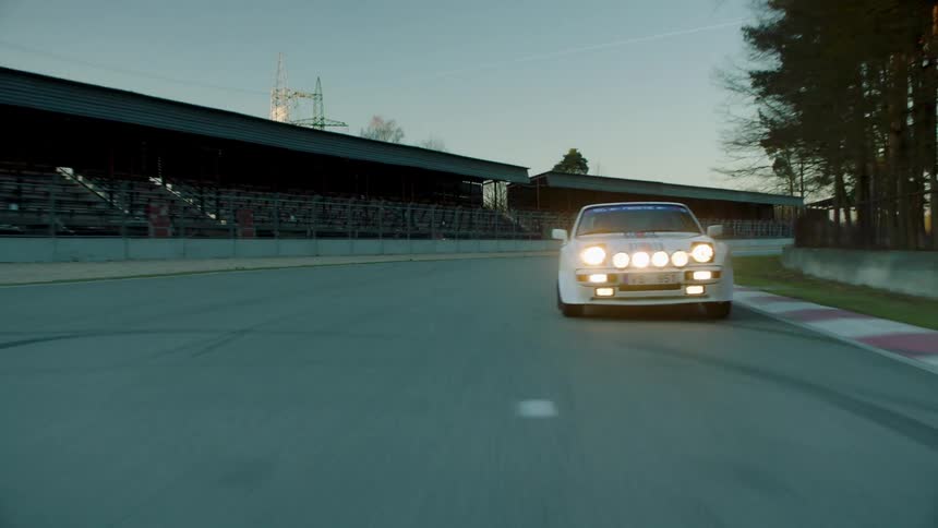 A race car is speeding on the track