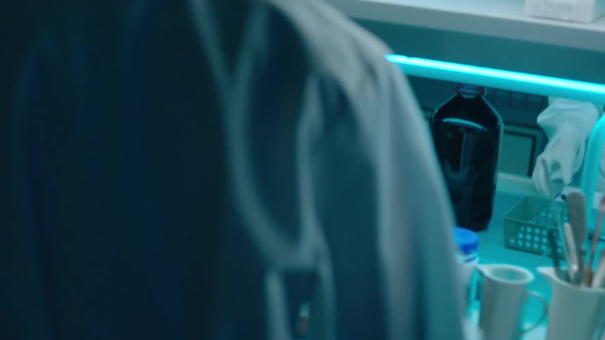 Woman with gloves working with laboratory equipment