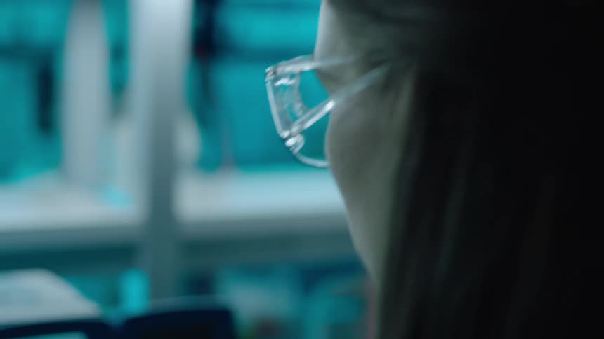 A scientist is using a machine in the lab