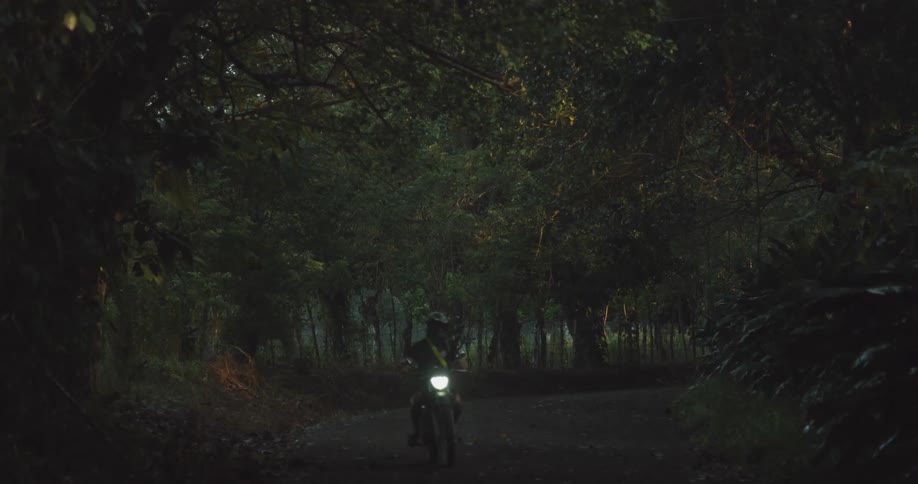 Riding a motorcycle on a mountain road at night