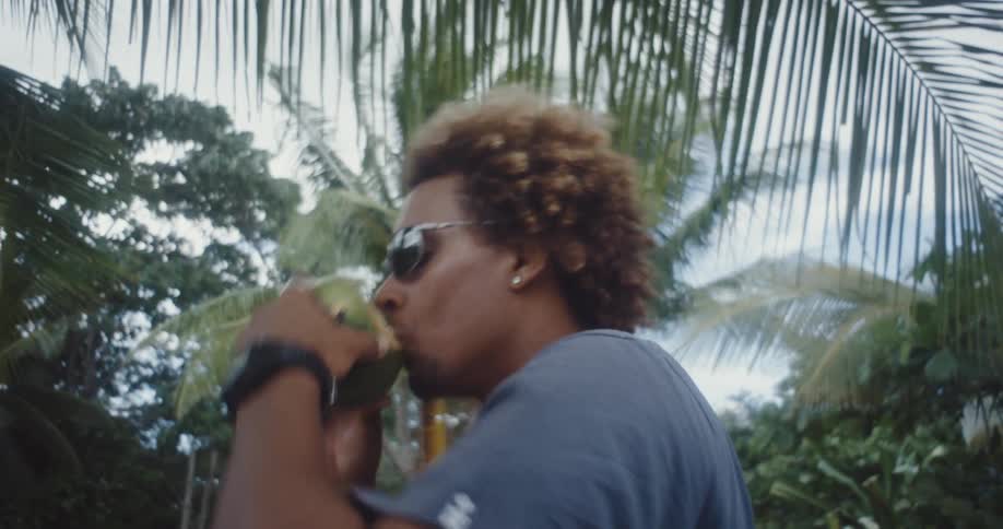 Man enjoying coconut water straight from the fruit