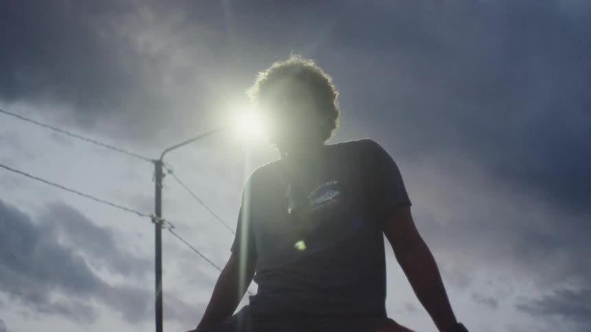 Man sitting against the sunlight