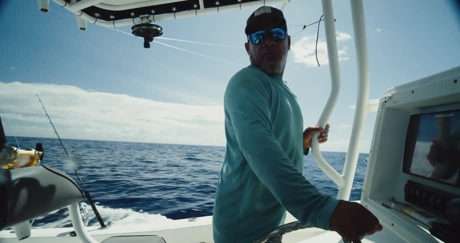 Man in a moving boat in the middle of the sea