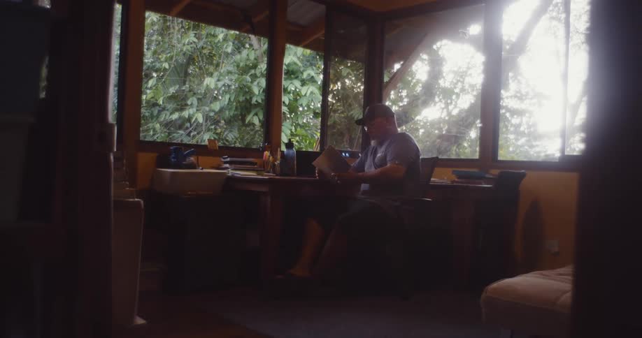 Man in cap sitting and reading a document