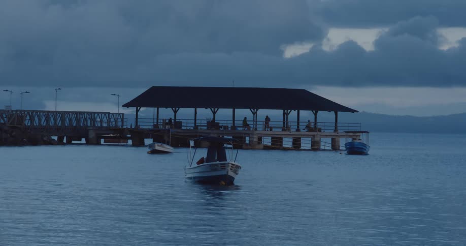 Pier in the sea with small boats