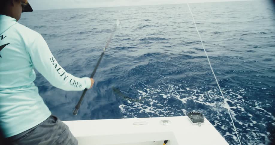 Fisherman man catching a fish in the ocean