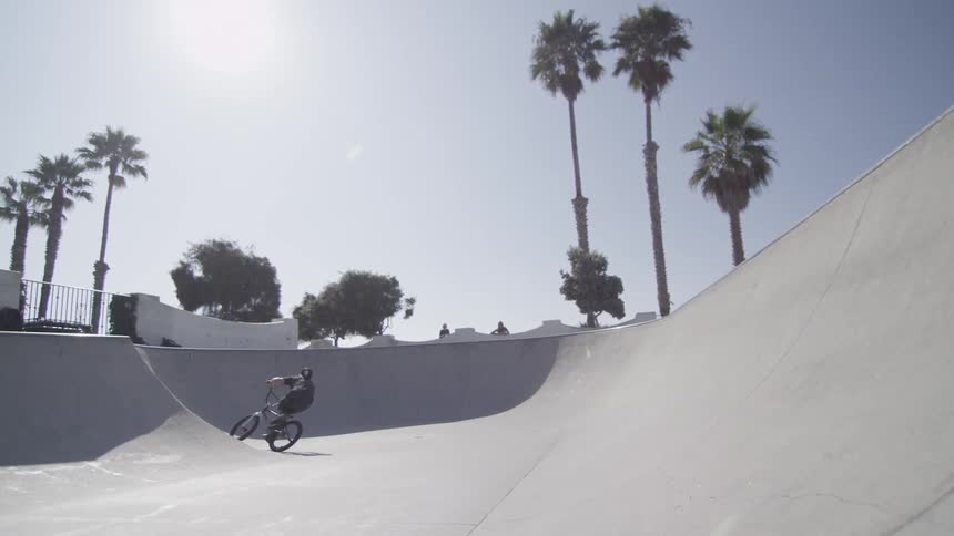 Man riding his bike up some hills