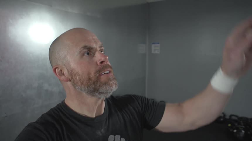 A man throwing a kettlebell