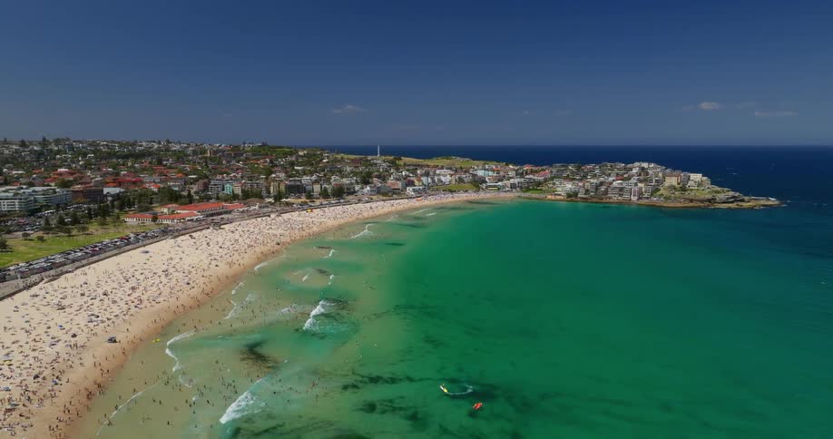 Aerial view of a beach with a crowd of people on a summer day