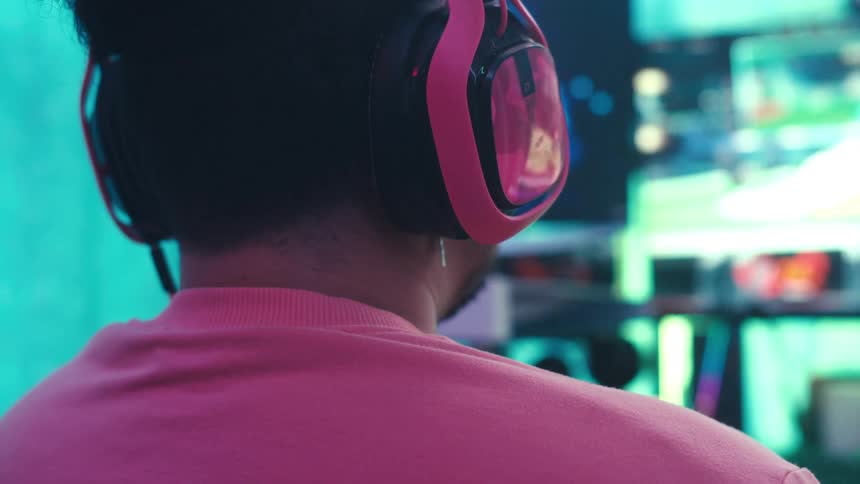 Man with headset sitting playing game
