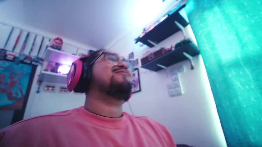 Man with headphone sitting getting happy while playing game