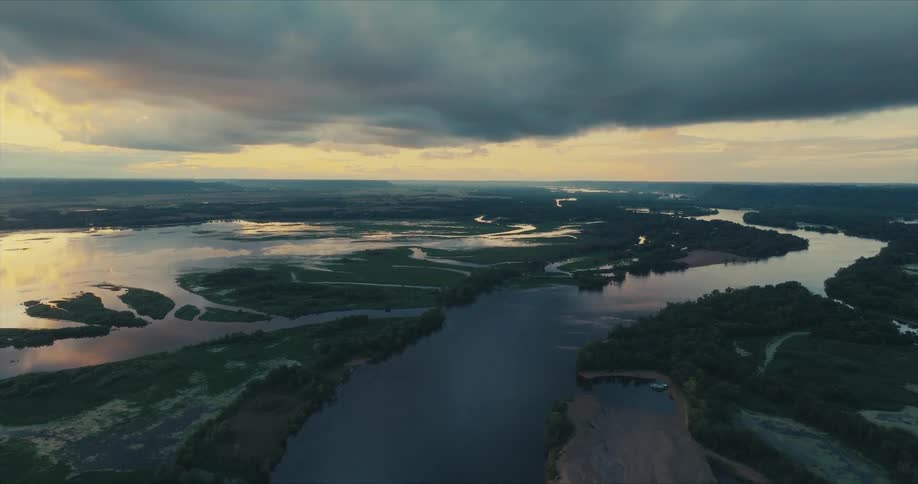 Dark storm clouds hover over a river