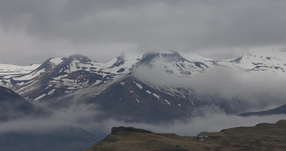 Landscape of a snowy mountain valley on a foggy day