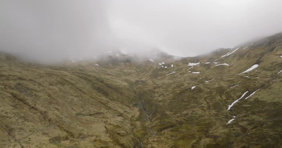 The clouds cover the mountain top