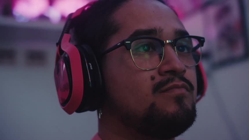 Portrait of a man with glasses using a headset