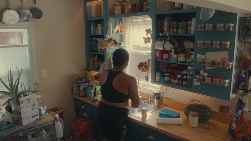 Person in kitchen washing dishes