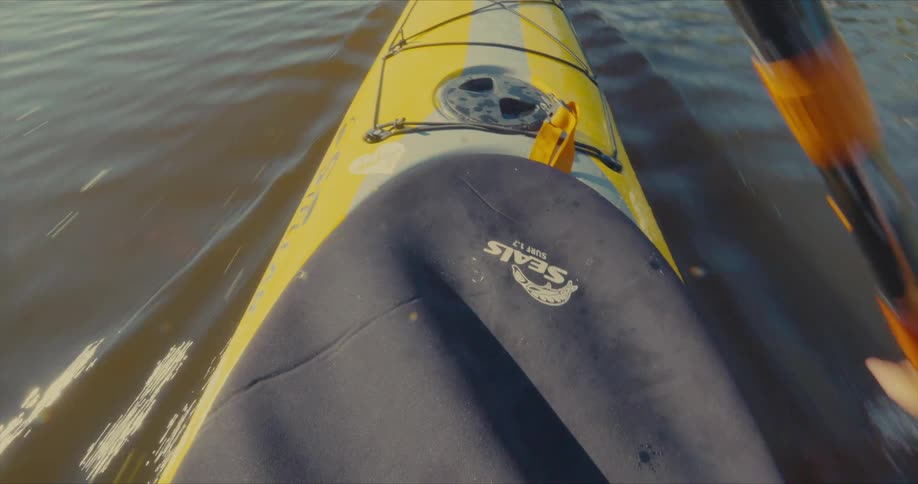 A person quickly paddles a kayak in the water