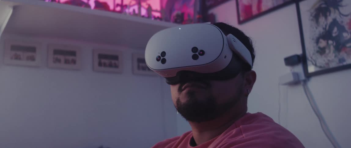 Man interacting with a virtual reality headset while standing in a room