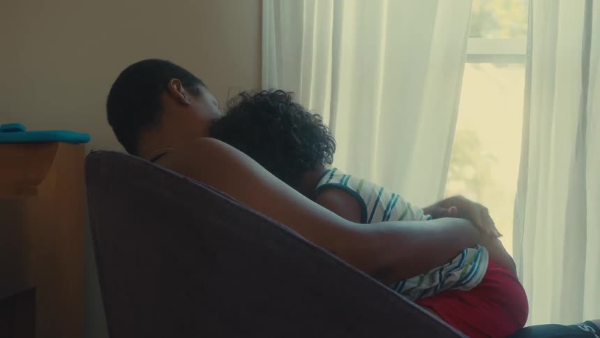 Father sitting in the armchair with his son