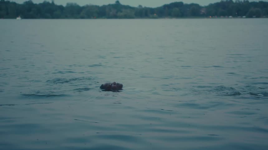 A person is floating in the water on their back