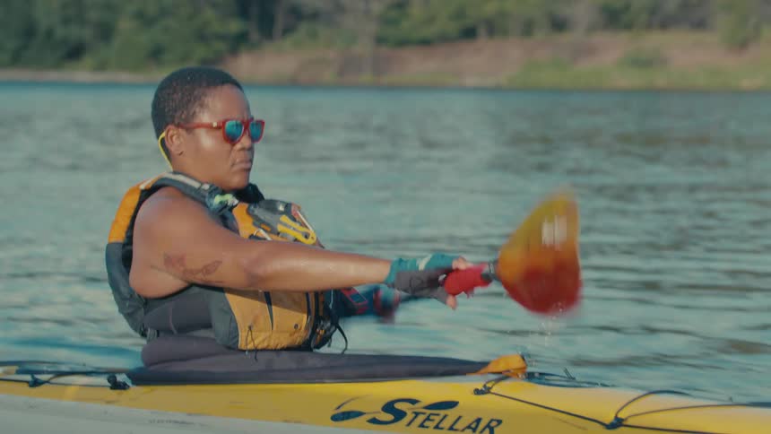 Person paddling canoeing on a river
