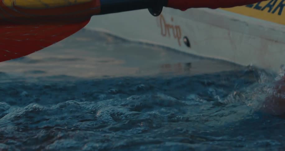 Person in a canoe running their hand through the water
