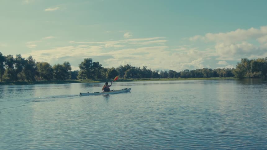 Person canoeing on a calm river
