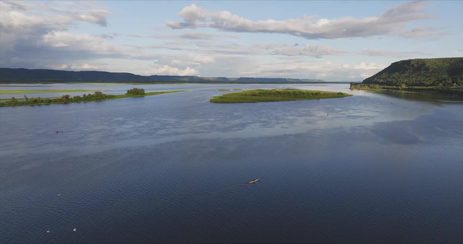 Small waves move on a lake surrounded by mountains