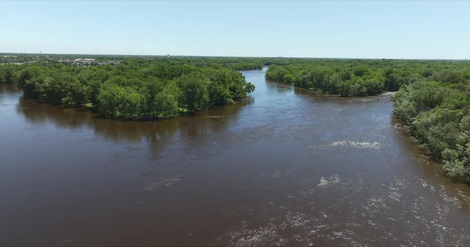 Aerial landscape of forest islands surrounded by a flowing river