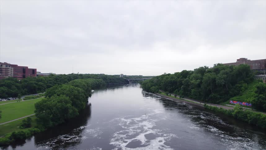 The river is lined with lush trees